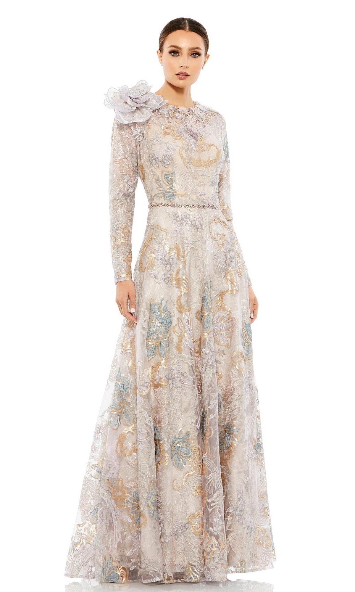 A woman models the Long Formal Dress 79374 by Mac Duggal, featuring an A-line silhouette, long sleeves, floral patterns, and an eye-catching floral shoulder accent against a plain white background.